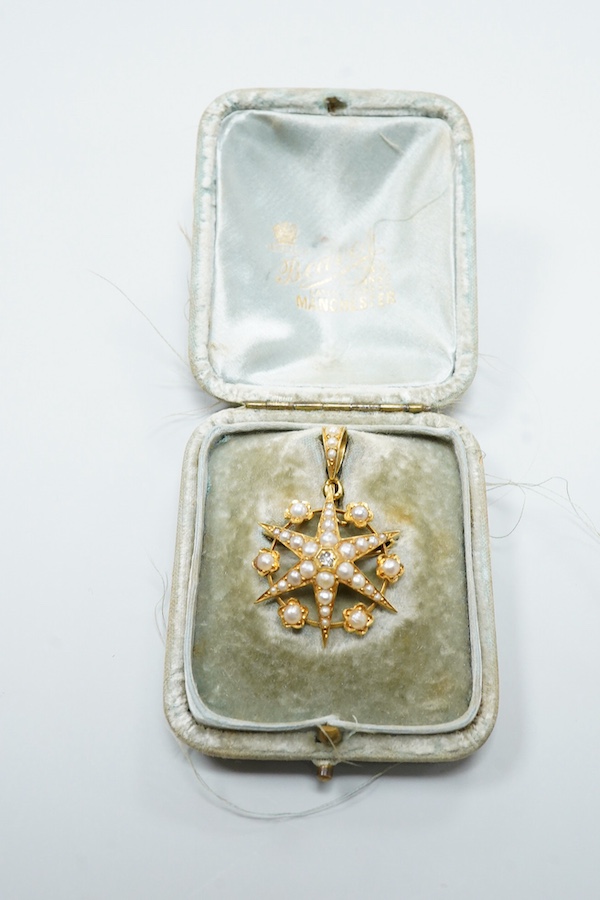 A Victorian yellow metal (stamped 18), diamond and graduated split pearl set star pendant brooch, makers mark SS, 39mm including the bale, gross weight 5.2 grams, with fitted box.